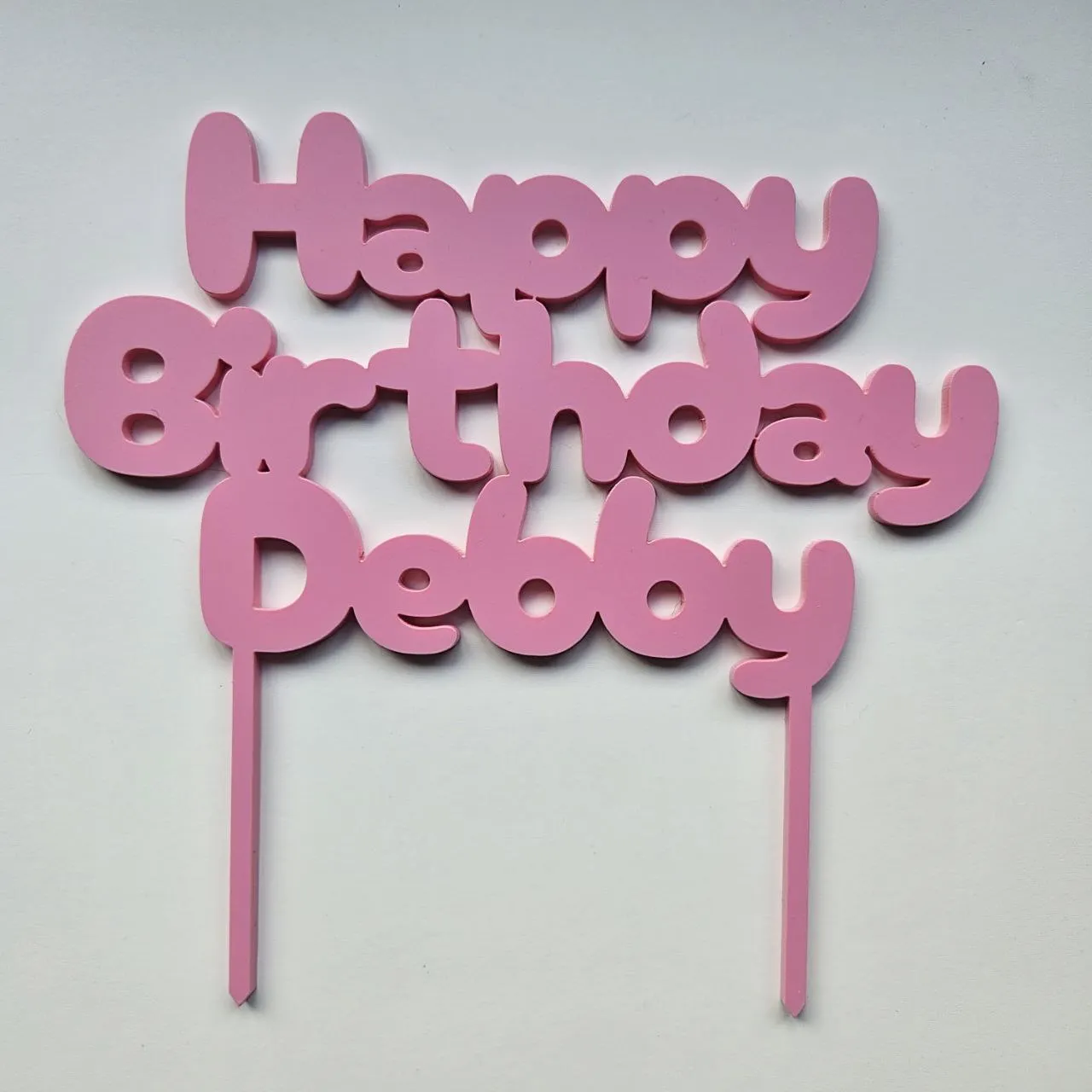 Two-stakes cake topper with 'Happy Birthday Debby' text